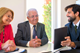 Financial adviser discussing aged care costs with older couple in Melbourne