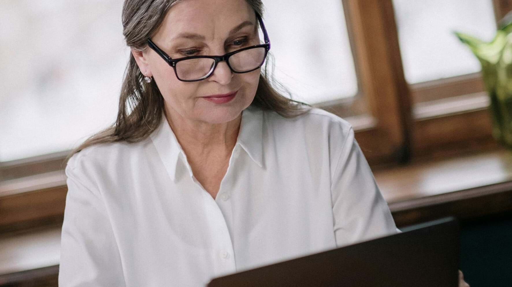 School administrator reviewing payroll and superannuation requirements on laptop for payday super compliance