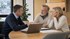 Mature couple discussing pre-retirement planning with a financial advisor