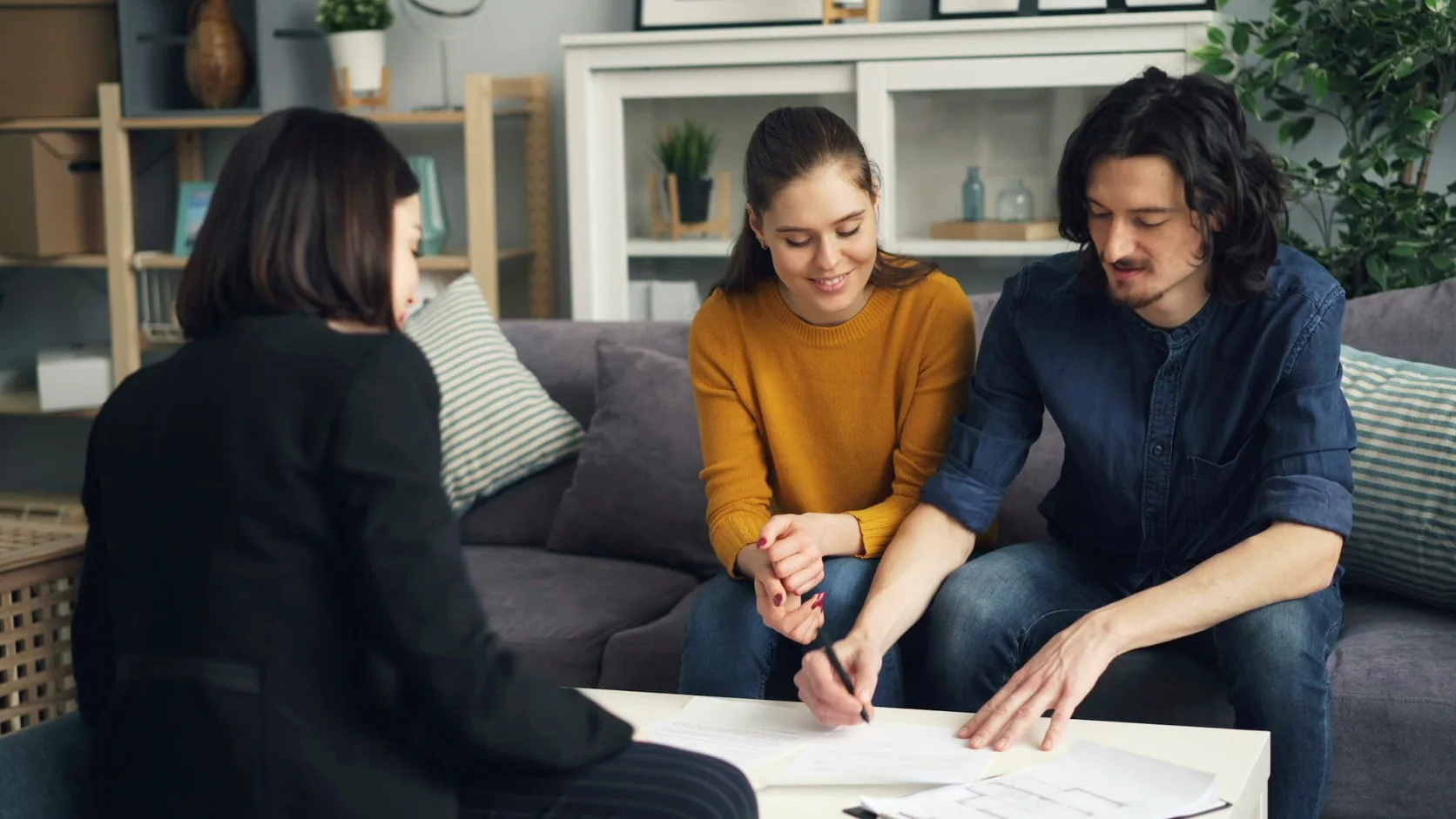 Couple reviewing property, tax and investment planning documents with a financial advisor.