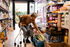Older shopper reviewing groceries in a store during a period of rising living costs