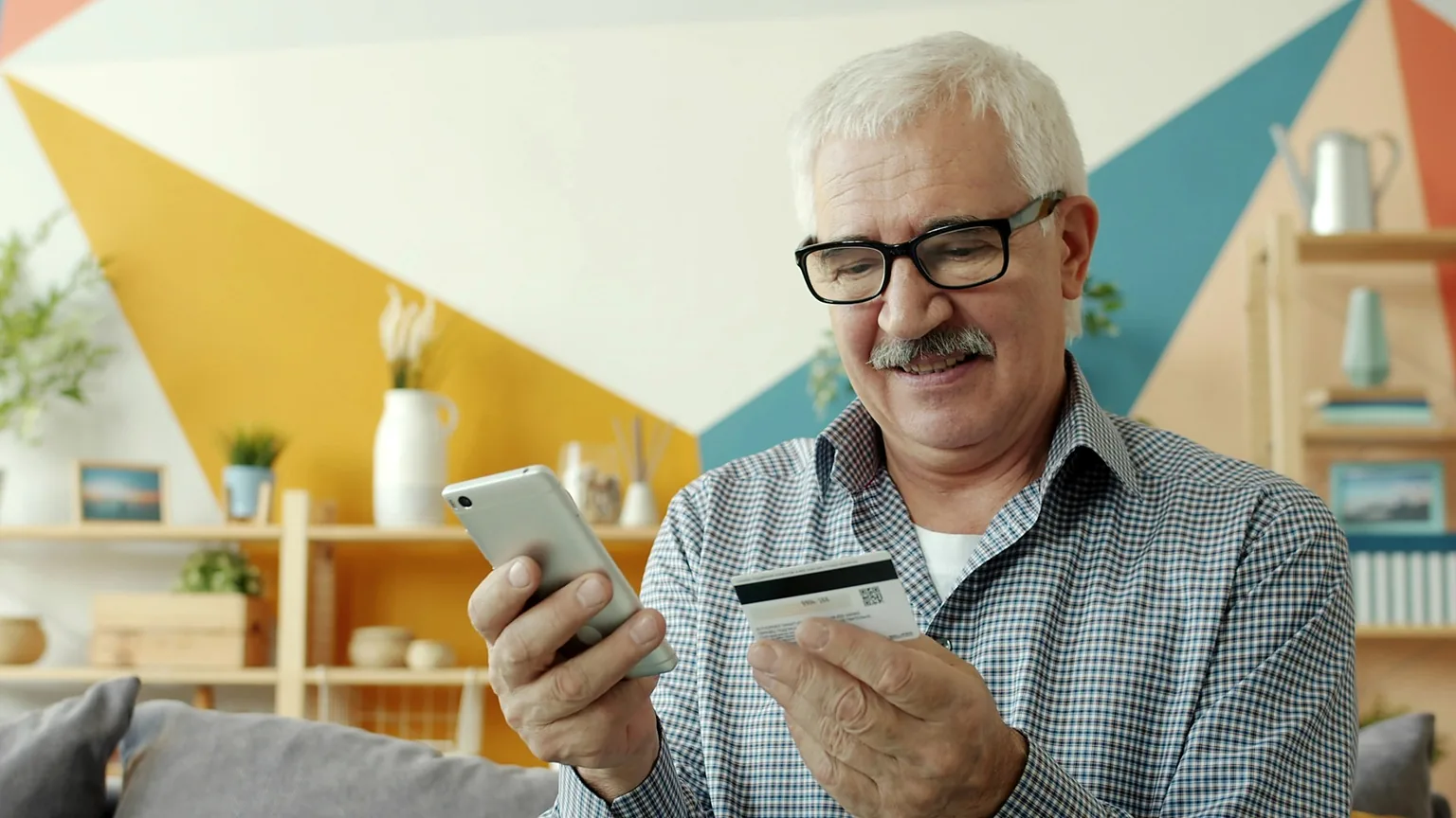 Older man reviewing financial details online as part of retirement planning